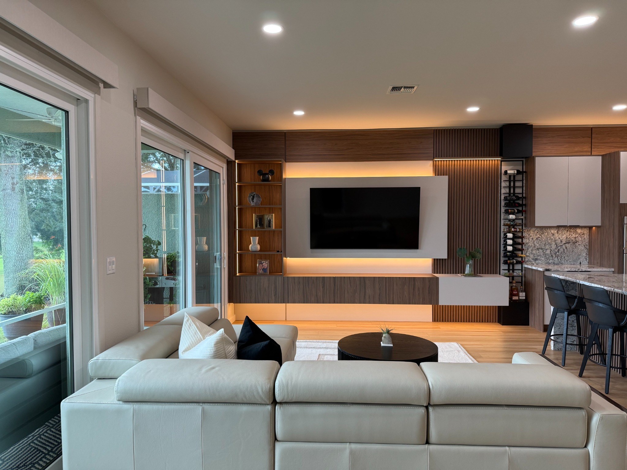 Contemporary living room with custom illuminated entertainment wall